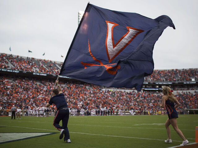 CHARLOTTESVILLE, VA - SEPTEMBER 03: Cheerleaders raise the Virginia Cavaliers flag after a UVA touchdown during a game against the Richmond Spiders at Scott Stadium on September 3, 2016 in Charlottesville, Virginia. Richmond beat Virginia 37-20 in the Virginia Cavaliers home opener.