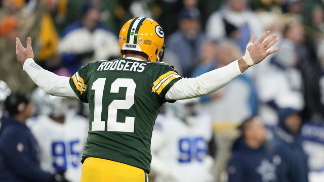GREEN BAY, WISCONSIN - NOVEMBER 13: Aaron Rodgers #12 of the Green Bay Packers celebrates after throwing a touchdown pass during the second quarter against the Dallas Cowboys at Lambeau Field on November 13, 2022 in Green Bay, Wisconsin.