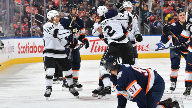 EDMONTON, CANADA - NOVEMBER 16: Connor McDavid #97 of the Edmonton Oilers looks on while Darnell Nurse #25 scrums with Alexander Edler #2 of the Los Angeles Kings during the game on November 16, 2022 at Rogers Place in Edmonton, Alberta, Canada.