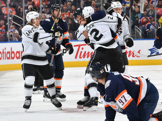 EDMONTON, CANADA - NOVEMBER 16: Connor McDavid #97 of the Edmonton Oilers looks on while Darnell Nurse #25 scrums with Alexander Edler #2 of the Los Angeles Kings during the game on November 16, 2022 at Rogers Place in Edmonton, Alberta, Canada.