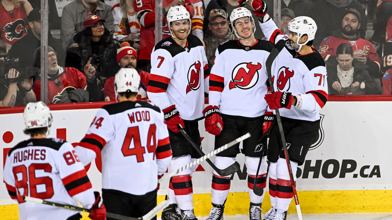 CALGARY, AB - NOVEMBER 05: New Jersey Devils Right Wing Nathan Bastian (14) celebrates a goal with New Jersey Devils Left Wing Miles Wood (44), New Jersey Devils Center Jack Hughes (86), New Jersey Devils Defenceman Dougie Hamilton (7) and New Jersey Devils Defenceman Jonas Siegenthaler (71) during the first period of an NHL game between the Calgary Flames and the New Jersey Devils on November 5, 2022, at the Scotiabank Saddledome in Calgary, AB.