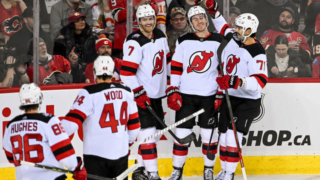 CALGARY, AB - NOVEMBER 05: New Jersey Devils Right Wing Nathan Bastian (14) celebrates a goal with New Jersey Devils Left Wing Miles Wood (44), New Jersey Devils Center Jack Hughes (86), New Jersey Devils Defenceman Dougie Hamilton (7) and New Jersey Devils Defenceman Jonas Siegenthaler (71) during the first period of an NHL game between the Calgary Flames and the New Jersey Devils on November 5, 2022, at the Scotiabank Saddledome in Calgary, AB.