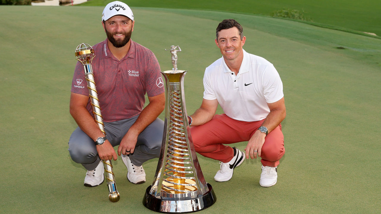DUBAI, UNITED ARAB EMIRATES - NOVEMBER 20: Jon Rahm of Spain (L) and Rory McIlroy of Northern Ireland pose with their trophies during Day Four of the DP World Tour Championship on the Earth Course at Jumeirah Golf Estates on November 20, 2022 in Dubai, United Arab Emirates.