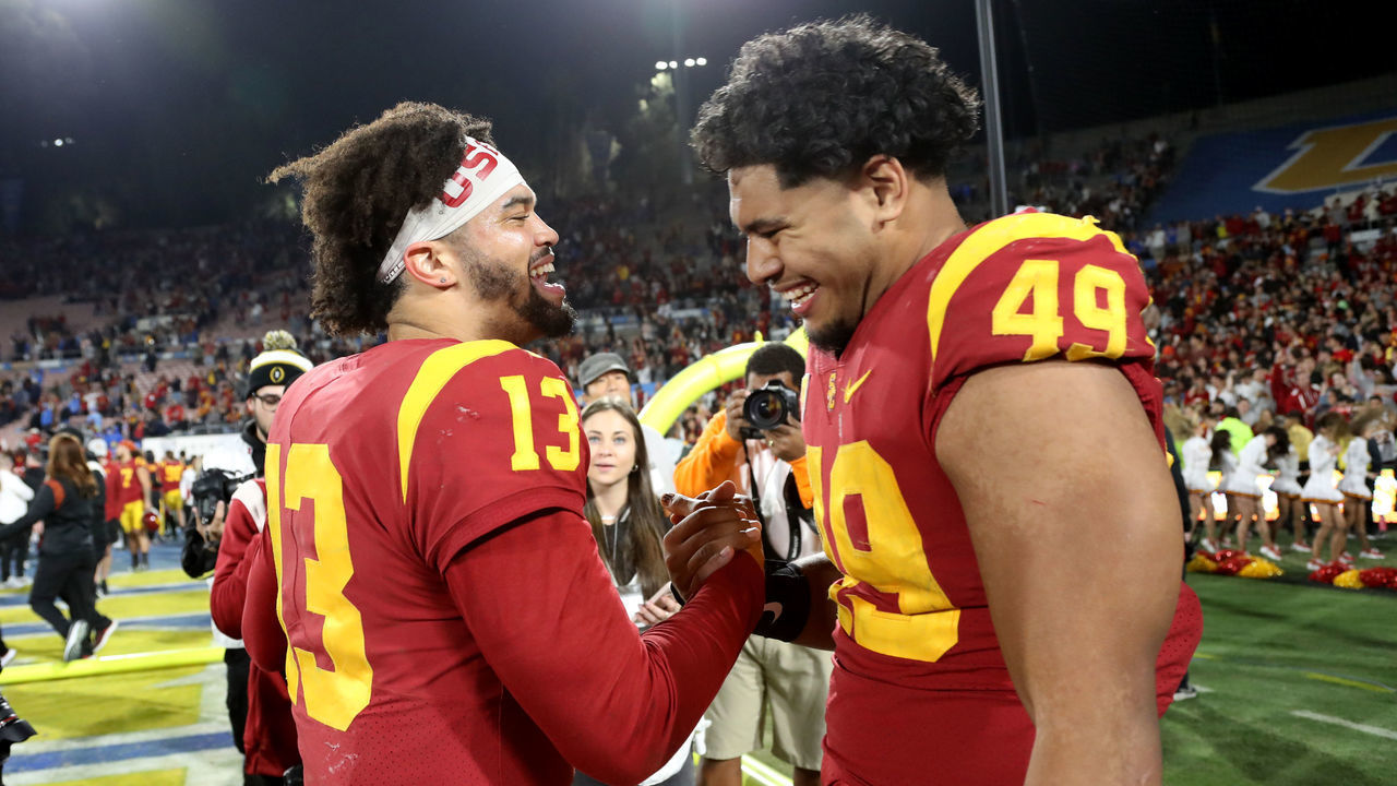 PASADENA, CA - NOVEMBER 19: USC Trojans quarterback Caleb Williams (13) and defensive lineman Tuli Tuipulotu (49) celebrate a victory against the UCLA Bruins after a college football game between the UCLA Bruins and the USC Trojans on November 19, 2022, at the Rose Bowl in Pasadena, CA.