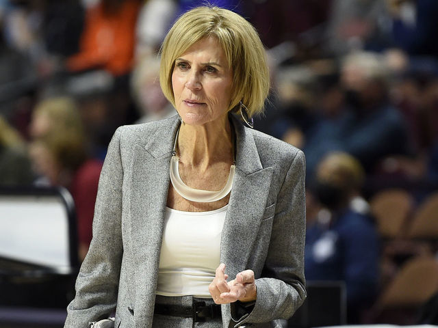 UNCASVILLE, CONNECTICUT - DECEMBER 19: Associate head coach Chris Dailey of the Connecticut Huskies watches the teams warm up before the game against the Louisville Cardinals in the Basketball Hall of Fame Women's Showcase at Mohegan Sun Arena on December 19, 2021 in Uncasville, Connecticut.