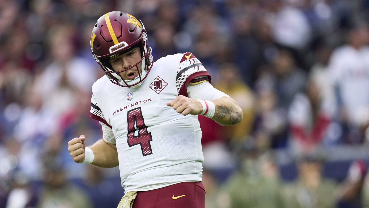 HOUSTON, TX - NOVEMBER 20: Taylor Heinicke #4 of the Washington Commanders celebrates after scoring a touchdown against the Houston Texans during the first half at NRG Stadium on November 20, 2022 in Houston, Texas.