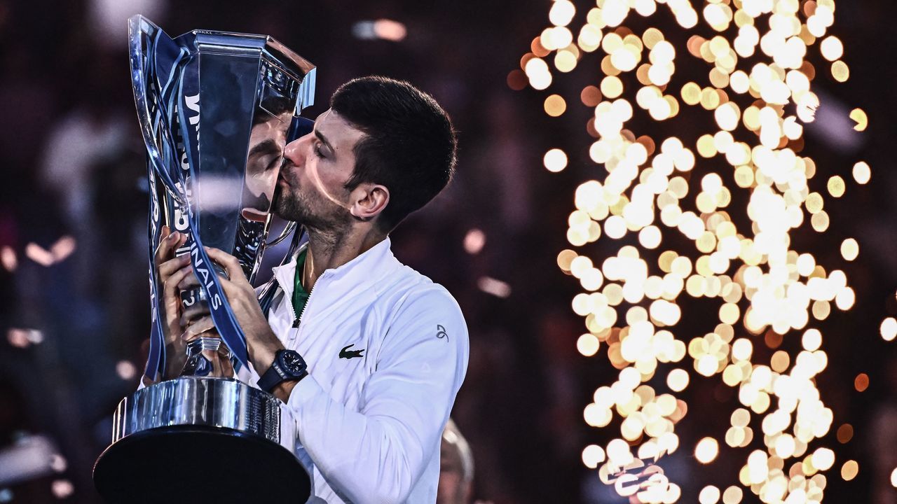Serbia's Novak Djokovic kisses the winner's trophy after winning the men's single final match against Norway's Casper Ruud on November 20, 2022 at the ATP Finals tennis tournament in Turin.