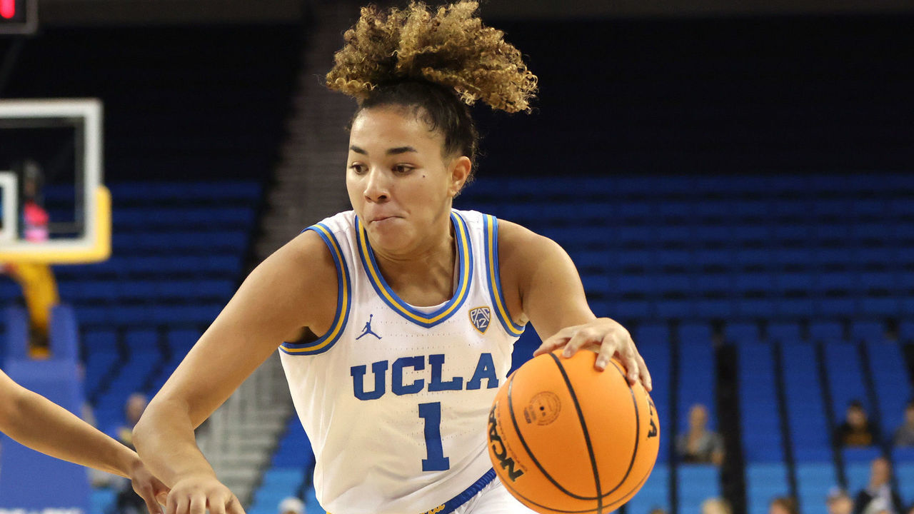 LOS ANGELES, CALIFORNIA - NOVEMBER 07: Kiki Rice #1 of the UCLA Bruins drives to the hoop as Taylor Wu #23 of the Cal Poly Mustangs defends during the first half of the game at UCLA Pauley Pavilion on November 07, 2022 in Los Angeles, California.