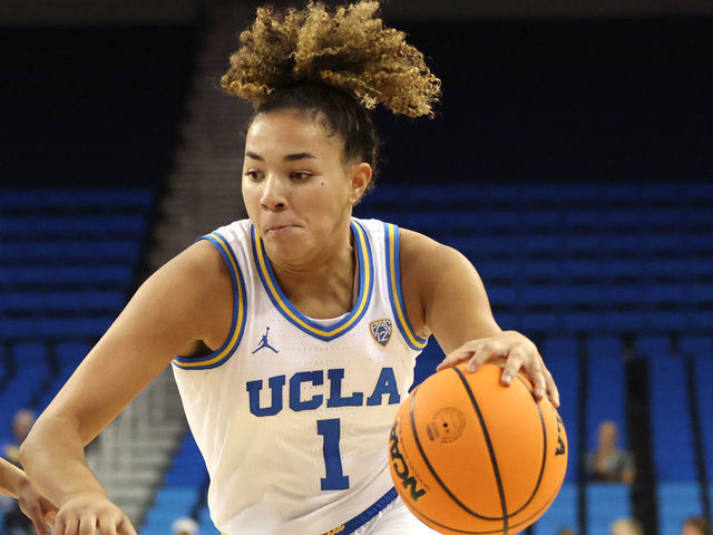 LOS ANGELES, CALIFORNIA - NOVEMBER 07: Kiki Rice #1 of the UCLA Bruins drives to the hoop as Taylor Wu #23 of the Cal Poly Mustangs defends during the first half of the game at UCLA Pauley Pavilion on November 07, 2022 in Los Angeles, California.