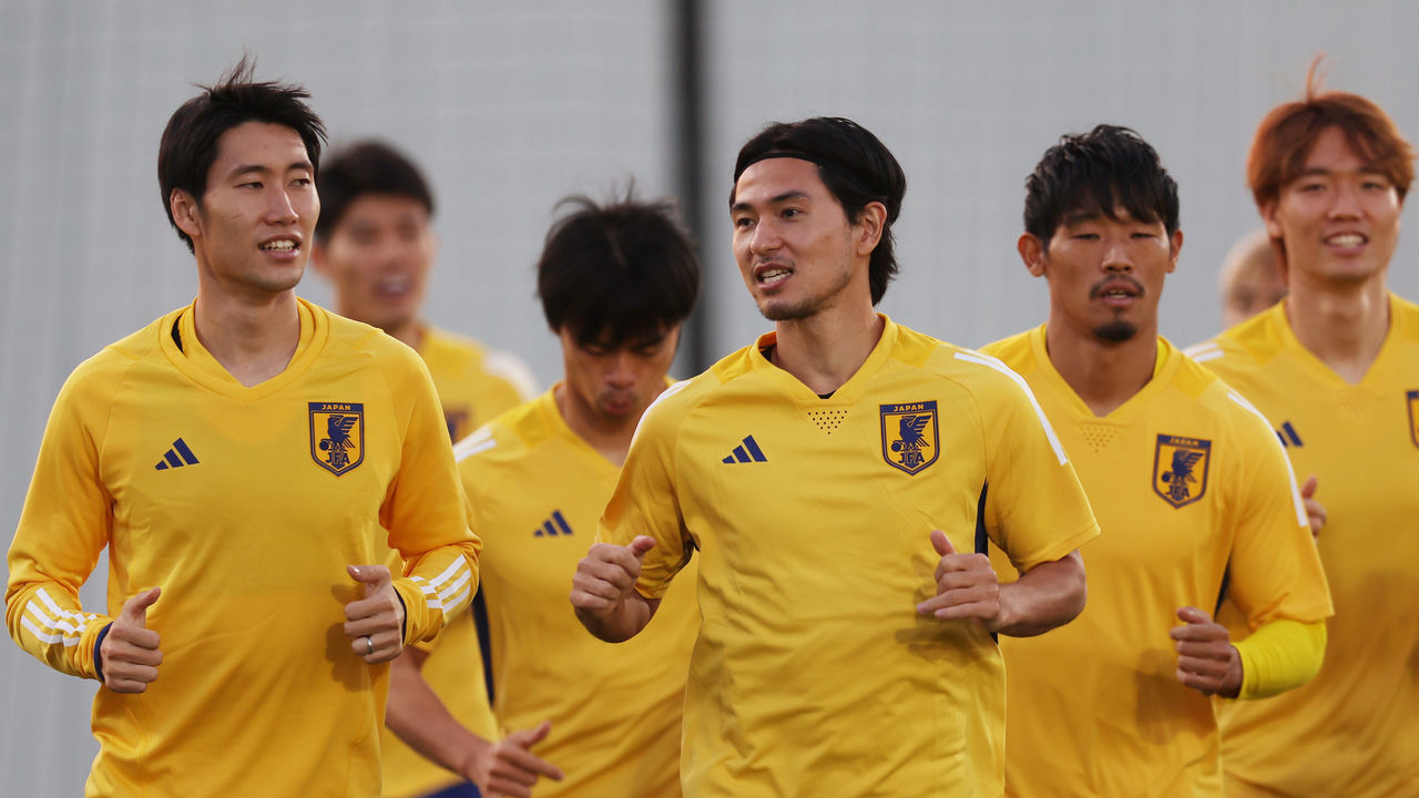 DOHA, QATAR - NOVEMBER 22: Takumi Minamino of Japan warms up with teammates during the Japan Training Session at Al Sadd New Training Facilities on November 22, 2022 in Doha, Qatar.