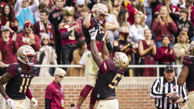 TALLAHASSEE, FLORIDA - NOVEMBER 19: Jordan Travis #13 and Maurice Smith #53 of the Florida State Seminoles celebrate after scoring a touchdown during the 1st quarter of a game against the Louisiana-Lafayette Ragin Cajuns at Doak Campbell Stadium on November 19, 2022 in Tallahassee, Florida.
