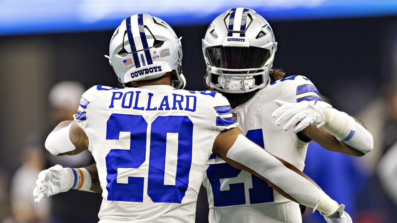 ARLINGTON, TEXAS - OCTOBER 2: Tony Pollard #20 and Ezekiel Elliott #21 of the Dallas Cowboys hug before a game against the Washington Commanders at AT&T Stadium on October 2, 2022 in Arlington, Texas. The Cowboys defeated the Commanders 25-10.