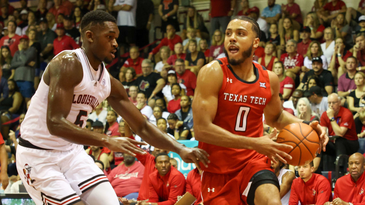 LAHAINA, HI - NOVEMBER 22: Kevin Obanor #0 of the Texas Tech Red Raiders dribbles as he is guarded by Brandon Huntley-Hatfield #5 of the Louisville Cardinals in the first half of the game during the Maui Invitational at Lahaina Civic Center on November 22, 2022 in Lahaina, Hawaii.