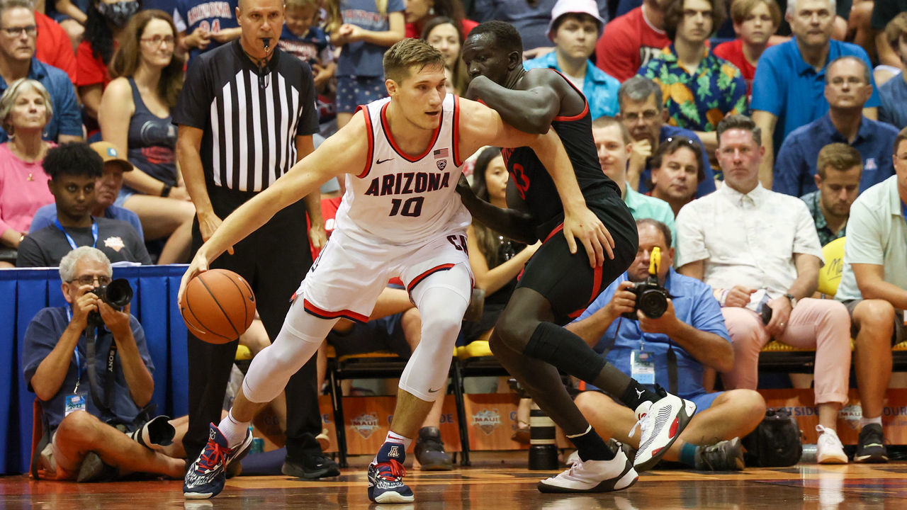 LAHAINA, HI - NOVEMBER 22: Azuolas Tubelis #10 of the Arizona Wildcats dribbles and is guarded by Aguek Arop #33 of the San Diego State Aztecs in the first half of the game during the Maui Invitational at Lahaina Civic Center on November 22, 2022 in Lahaina, Hawaii.