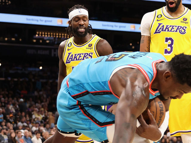 PHOENIX, ARIZONA - NOVEMBER 22: Patrick Beverley #21 of the Los Angeles Lakers pushes Deandre Ayton #22 of the Phoenix Suns to the court over Austin Reaves #15 during the second half of the NBA game at Footprint Center on November 22, 2022 in Phoenix, Arizona. Beverley was ejected on the play. The Suns defeated the Lakers 115-105.