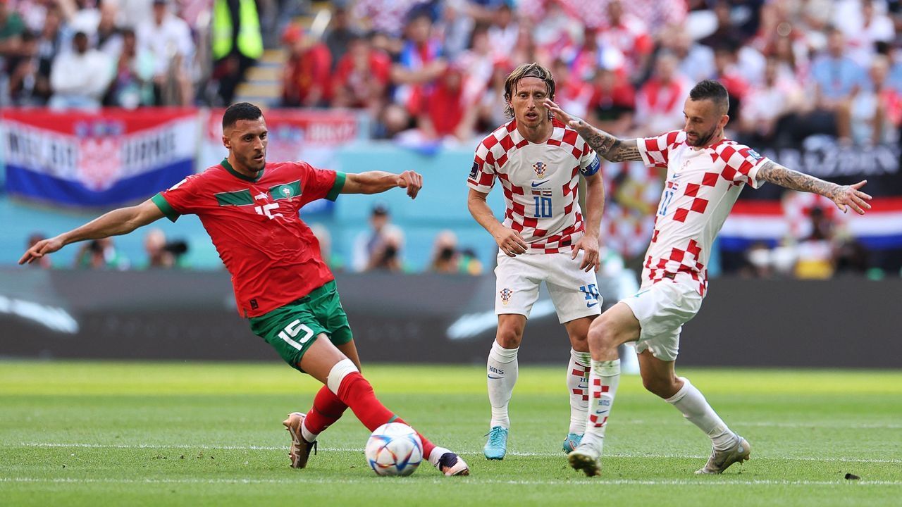 Morocco's midfielder #15 Selim Amallah, Croatia's midfielder #10 Luka Modric and Croatia's midfielder #11 Marcelo Brozovic fight for the ball during the Qatar 2022 World Cup Group F football match between Morocco and Croatia at the Al-Bayt Stadium in Al Khor, north of Doha on November 23, 2022.
