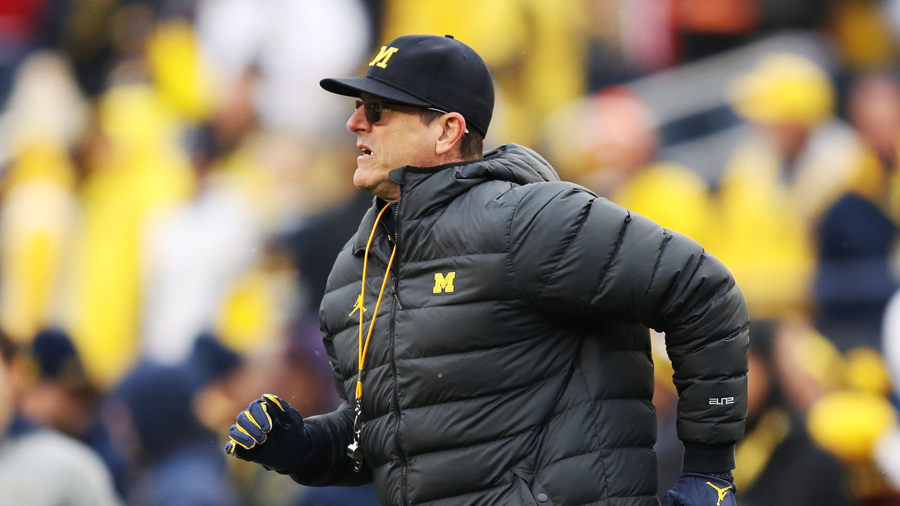 ANN ARBOR, MICHIGAN - NOVEMBER 27: Head coach Jim Harbaugh of the Michigan Wolverines runs on the field during warm-ups prior to the game against the Ohio State Buckeyes at Michigan Stadium on November 27, 2021 in Ann Arbor, Michigan.