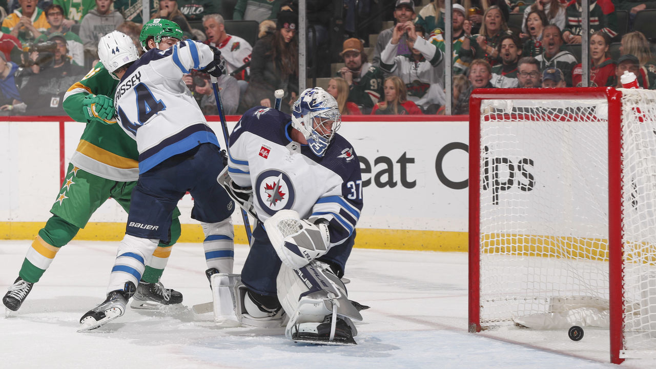 SAINT PAUL, MN - NOVEMBER 23: Mason Shaw #15 scores a goal while his teammate Connor Dewar #26 of the Minnesota Wild is defended by Josh Morrissey #44 and Connor Hellebuyck #37of the Winnipeg Jets during the game at the Xcel Energy Center on November 23, 2022 in Saint Paul, Minnesota.