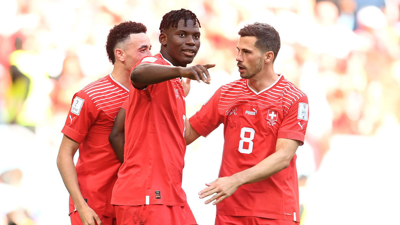 AL WAKRAH, QATAR - NOVEMBER 24: Breel Embolo (C) of Switzerland celebrates scoring their first goal with their teammates Ruben Vargas (L) and Remo Freuler (R) during the FIFA World Cup Qatar 2022 Group G match between Switzerland and Cameroon at Al Janoub Stadium on November 24, 2022 in Al Wakrah, Qatar.