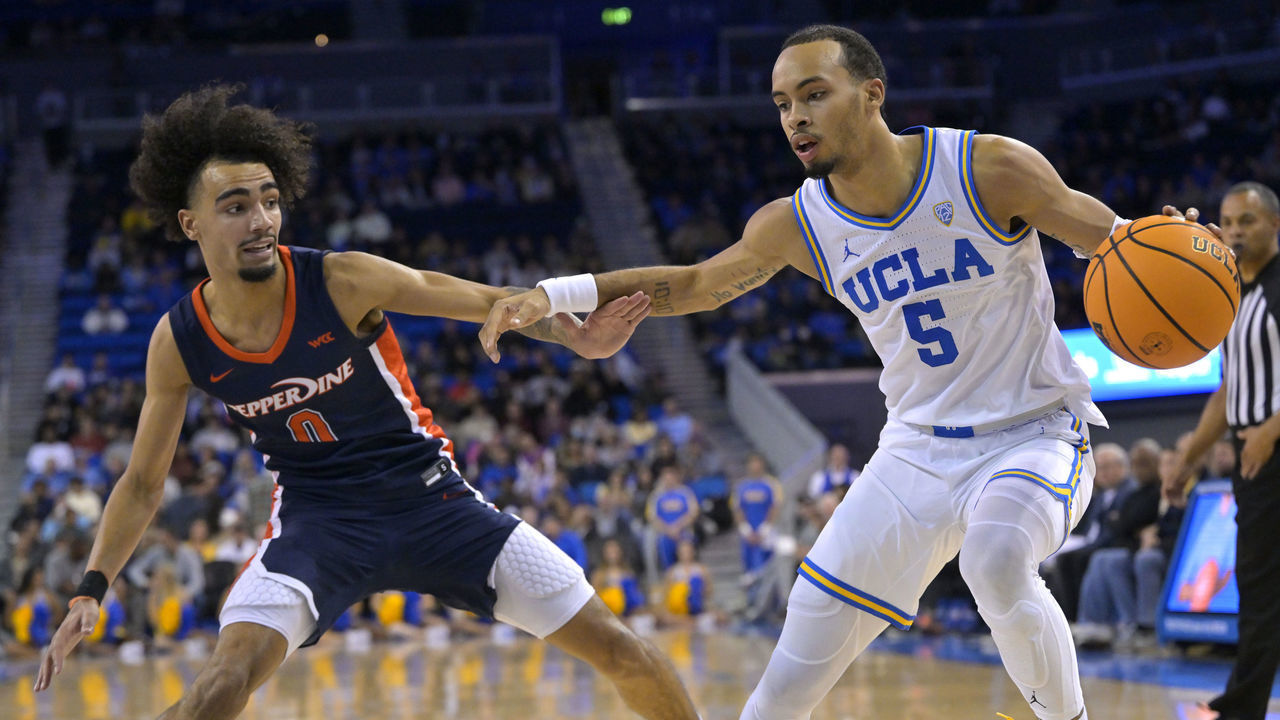 LOS ANGELES, CA - NOVEMBER 23: Amari Bailey #5 of the UCLA Bruins is guarded by past Maxwell Lewis #24 of the Pepperdine Waves at UCLA Pauley Pavilion on November 23, 2022 in Los Angeles, California.