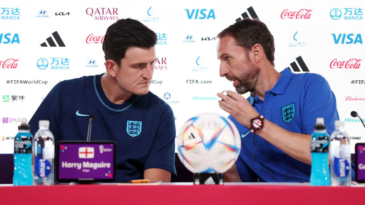 DOHA, QATAR - NOVEMBER 24: Harry Maguire of England and Gareth Southgate, Head Coach of England, interact during the England Press Conference at the Main Media Center on November 24, 2022 in Doha, Qatar.