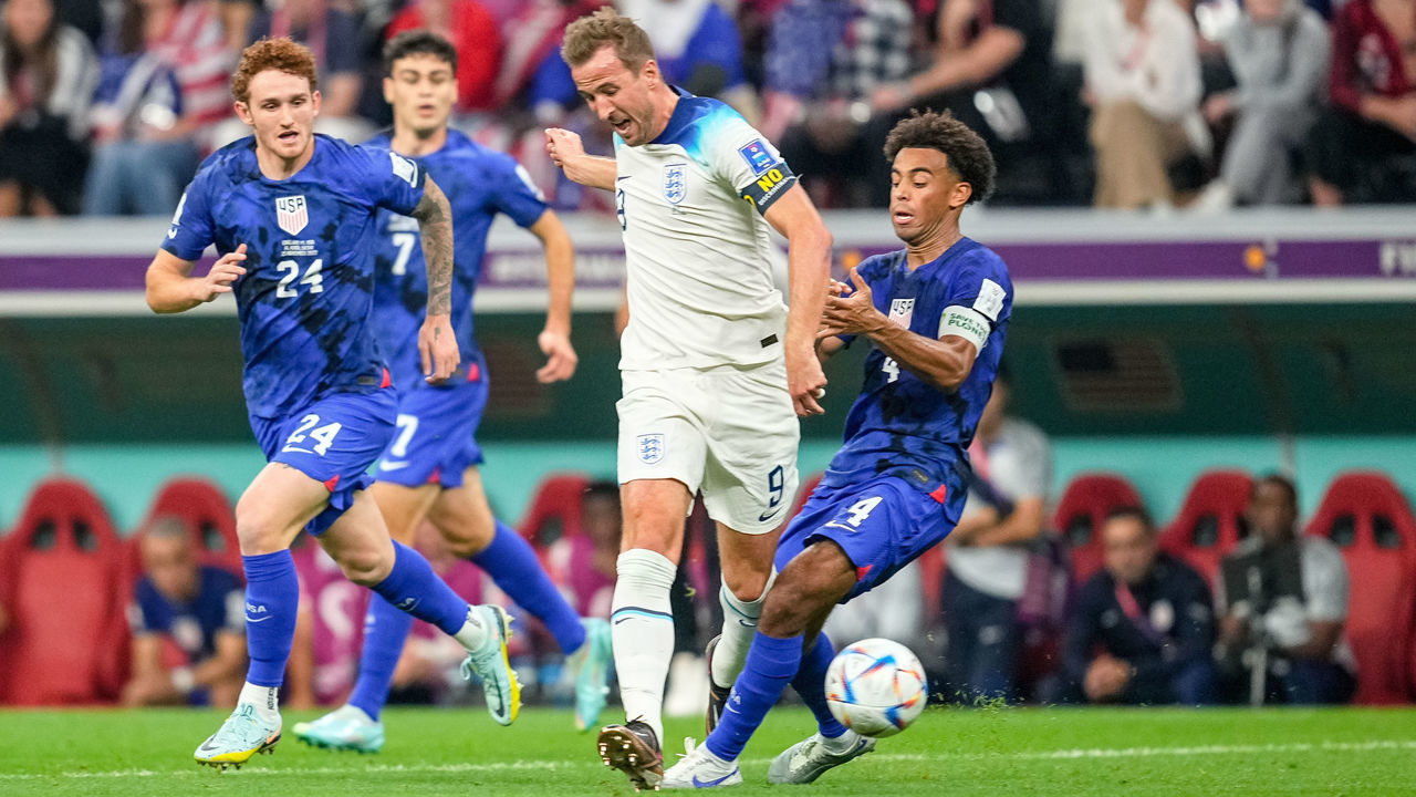 AL KHOR, QATAR - NOVEMBER 25: Harry Kane of England and Tyler Adams of USA battle for the ball during the FIFA World Cup Qatar 2022 Group B match between England and USA at Al Bayt Stadium on November 25, 2022 in Al Khor, Qatar.