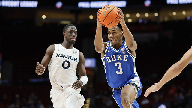 PORTLAND, OREGON - NOVEMBER 25: Jeremy Roach #3 of the Duke Blue Devils drives for the basket between Souley Boum #0 and Desmond Claude #1 of the Xavier Musketeers during the second half at Moda Center on November 25, 2022 in Portland, Oregon.