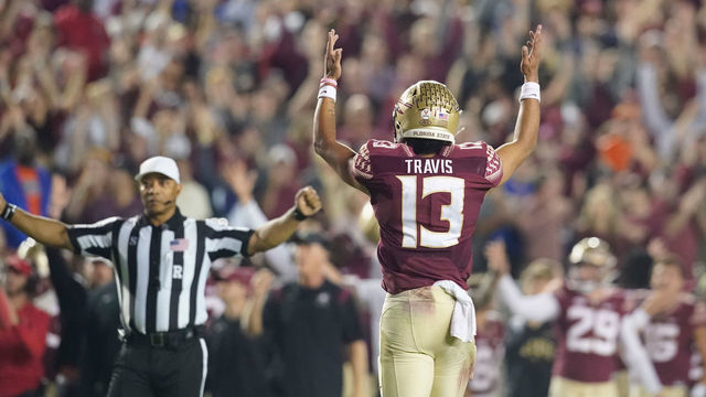 TALLAHASSEE, FL - NOVEMBER 25: Florida State Seminoles quarterback Jordan Travis (13) signals for a touchdown during the Florida State Seminoles game versus the Florida Gators on November 25, 2022, at Doak Campbell Stadium in Tallahassee, FL.