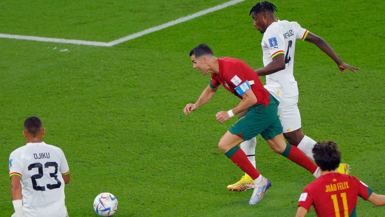 Ghana's defender #04 Mohammed Salisu (R) fouls Portugal's forward #07 Cristiano Ronaldo in the area to commit a penalty during the Qatar 2022 World Cup Group H football match between Portugal and Ghana at Stadium 974 in Doha on November 24, 2022.