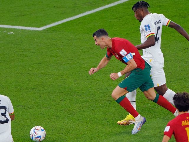 Ghana's defender #04 Mohammed Salisu (R) fouls Portugal's forward #07 Cristiano Ronaldo in the area to commit a penalty during the Qatar 2022 World Cup Group H football match between Portugal and Ghana at Stadium 974 in Doha on November 24, 2022.