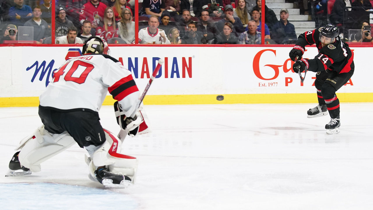 OTTAWA, CANADA - NOVEMBER 19: Tyler Motte #14 of the Ottawa Senators shoots the puck against Akira Schmid #40 of the New Jersey Devils at Canadian Tire Centre on November 19, 2022 in Ottawa, Ontario, Canada.