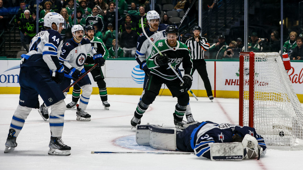 DALLAS, TX - NOVEMBER 25: Dallas Stars center Joe Pavelski (16) celebrates a goal as Winnipeg Jets goaltender Connor Hellebuyck (37) lays on the ice during the game between the Dallas Stars and the Winnipeg Jets on November 25, 2022 at American Airlines Center in Dallas, Texas.