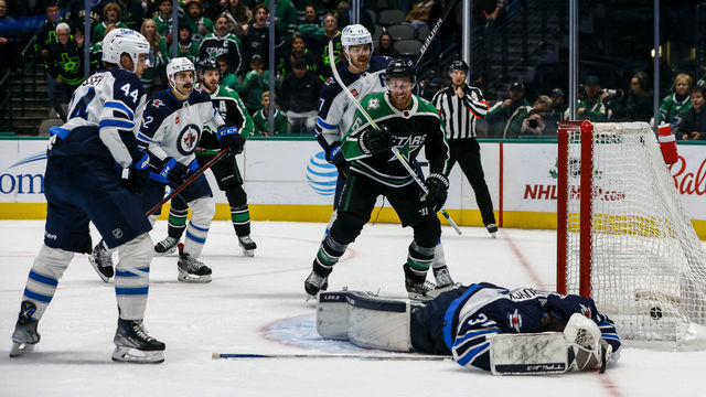 DALLAS, TX - NOVEMBER 25: Dallas Stars center Joe Pavelski (16) celebrates a goal as Winnipeg Jets goaltender Connor Hellebuyck (37) lays on the ice during the game between the Dallas Stars and the Winnipeg Jets on November 25, 2022 at American Airlines Center in Dallas, Texas.