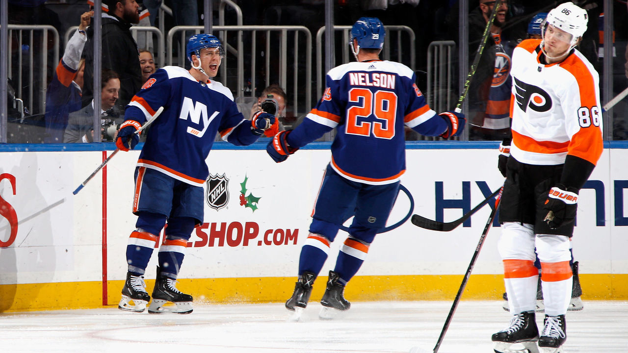 ELMONT, NEW YORK - NOVEMBER 26: Anthony Beauvillier #18 of the New York Islanders scores a third period goal against the Philadelphia Flyers and is joined by Brock Nelson #29 at the UBS Arena on November 26, 2022 in Elmont, New York.