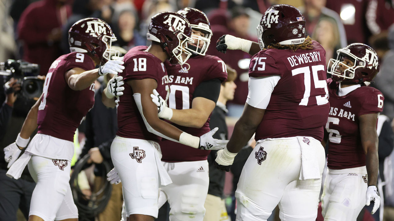 COLLEGE STATION, TEXAS - NOVEMBER 26: Donovan Green #18 celebrates his touchdown with Evan Stewart #1, Noah Thomas #9, and Kam Dewberry #75 of the Texas A&M Aggies during the first half against the LSU Tigers at Kyle Field on November 26, 2022 in College Station, Texas.