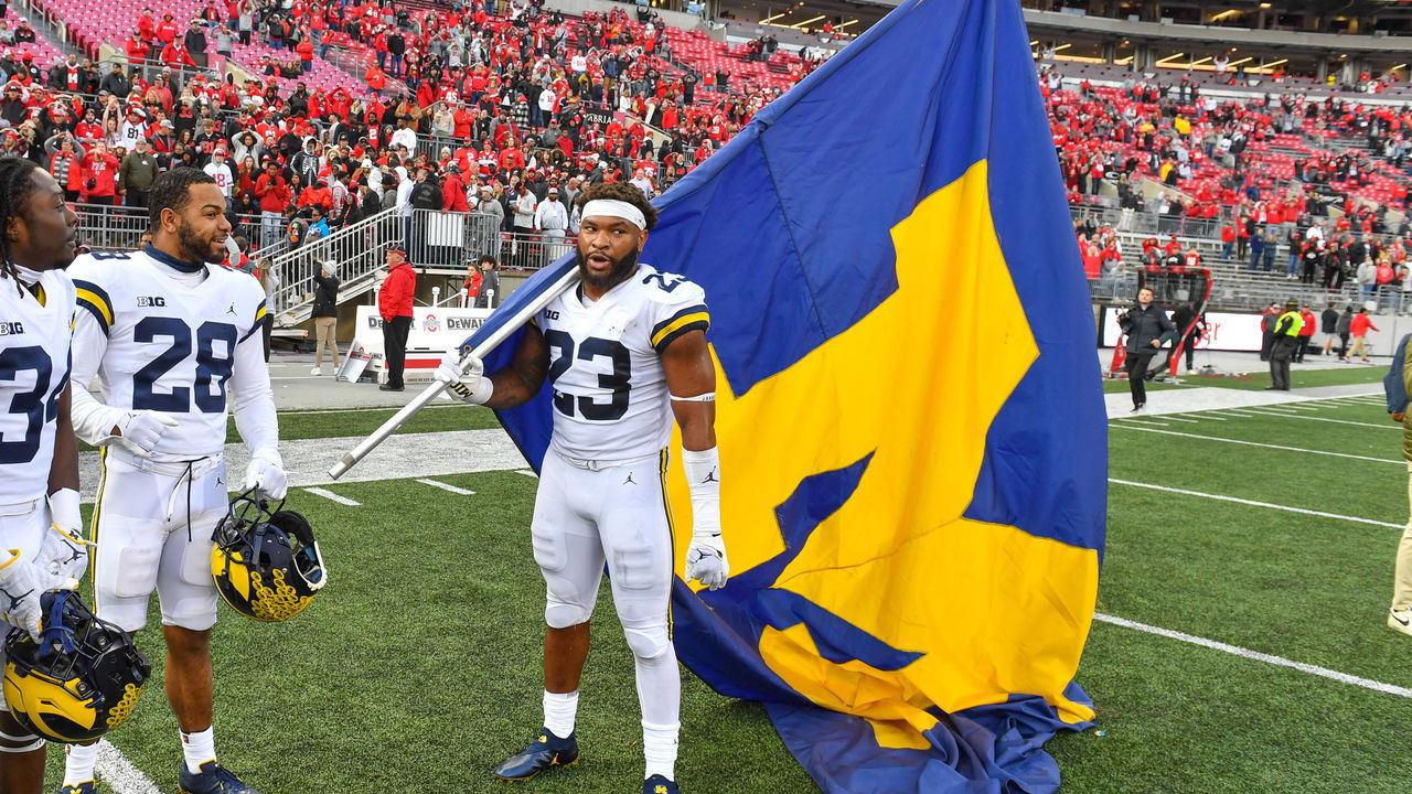 COLUMBUS, OHIO - NOVEMBER 26: Michael Barrett #23 of the Michigan Wolverines celebrates with the University of Michigan Flag after a college football game against the Ohio State Buckeyes at Ohio Stadium on November 26, 2022 in Columbus, Ohio. The Michigan Wolverines won the game 45-23 over the Ohio State Buckeyes and clinched the Big Ten East.