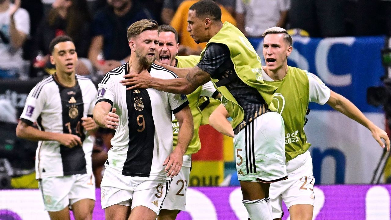 Germany's forward #09 Niclas Fullkrug (2nd L) celebrates with teammantes after scoring his team's first goal during the Qatar 2022 World Cup Group E football match between Spain and Germany at the Al-Bayt Stadium in Al Khor, north of Doha on November 27, 2022.