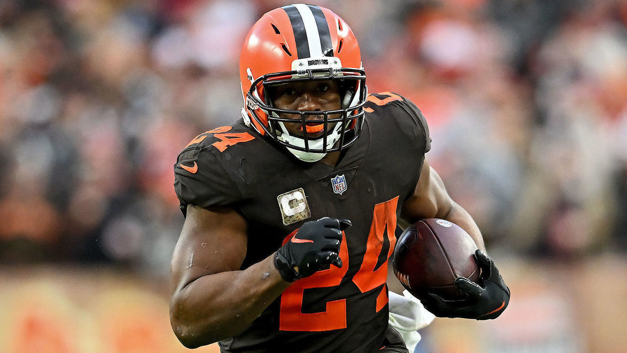 CLEVELAND, OHIO - NOVEMBER 27: Nick Chubb #24 of the Cleveland Browns runs with the ball as Jamel Dean #35 of the Tampa Bay Buccaneers defends. during the second half at FirstEnergy Stadium on November 27, 2022 in Cleveland, Ohio.