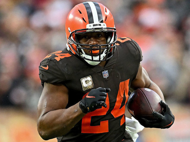 CLEVELAND, OHIO - NOVEMBER 27: Nick Chubb #24 of the Cleveland Browns runs with the ball as Jamel Dean #35 of the Tampa Bay Buccaneers defends. during the second half at FirstEnergy Stadium on November 27, 2022 in Cleveland, Ohio.