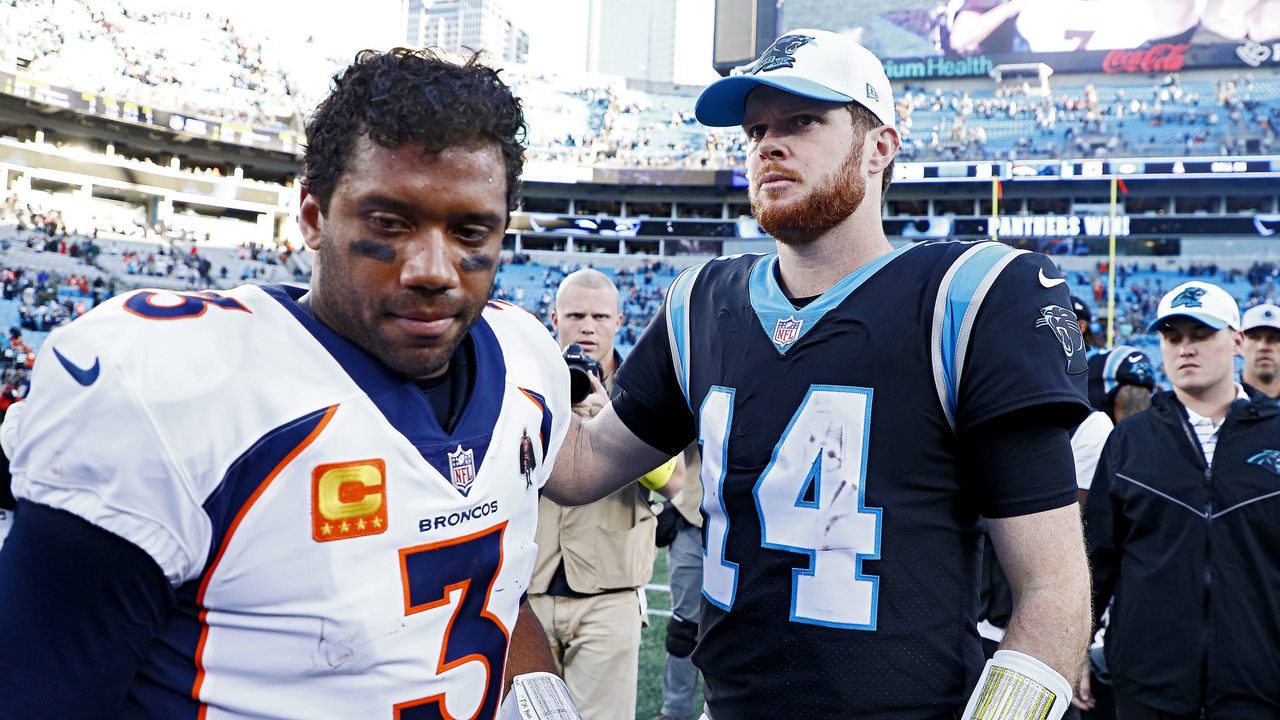 CHARLOTTE, NORTH CAROLINA - NOVEMBER 27: Russell Wilson #3 of the Denver Broncos and Sam Darnold #14 of the Carolina Panthers talk after a game at Bank of America Stadium on November 27, 2022 in Charlotte, North Carolina.