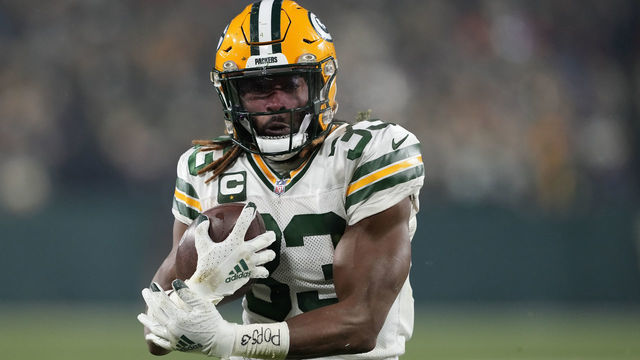 GREEN BAY, WISCONSIN - NOVEMBER 17: Aaron Jones #33 of the Green Bay Packers scores a two point conversion against the Tennessee Titans during the third quarter in the game at Lambeau Field on November 17, 2022 in Green Bay, Wisconsin.