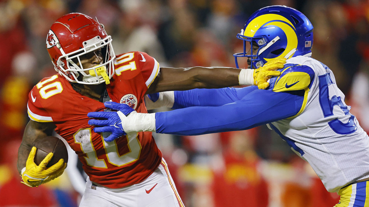 KANSAS CITY, MISSOURI - NOVEMBER 27: Isiah Pacheco #10 of the Kansas City Chiefs runs with the ball as. Leonard Floyd #54 of the Los Angeles Rams defends during the second half at Arrowhead Stadium on November 27, 2022 in Kansas City, Missouri.