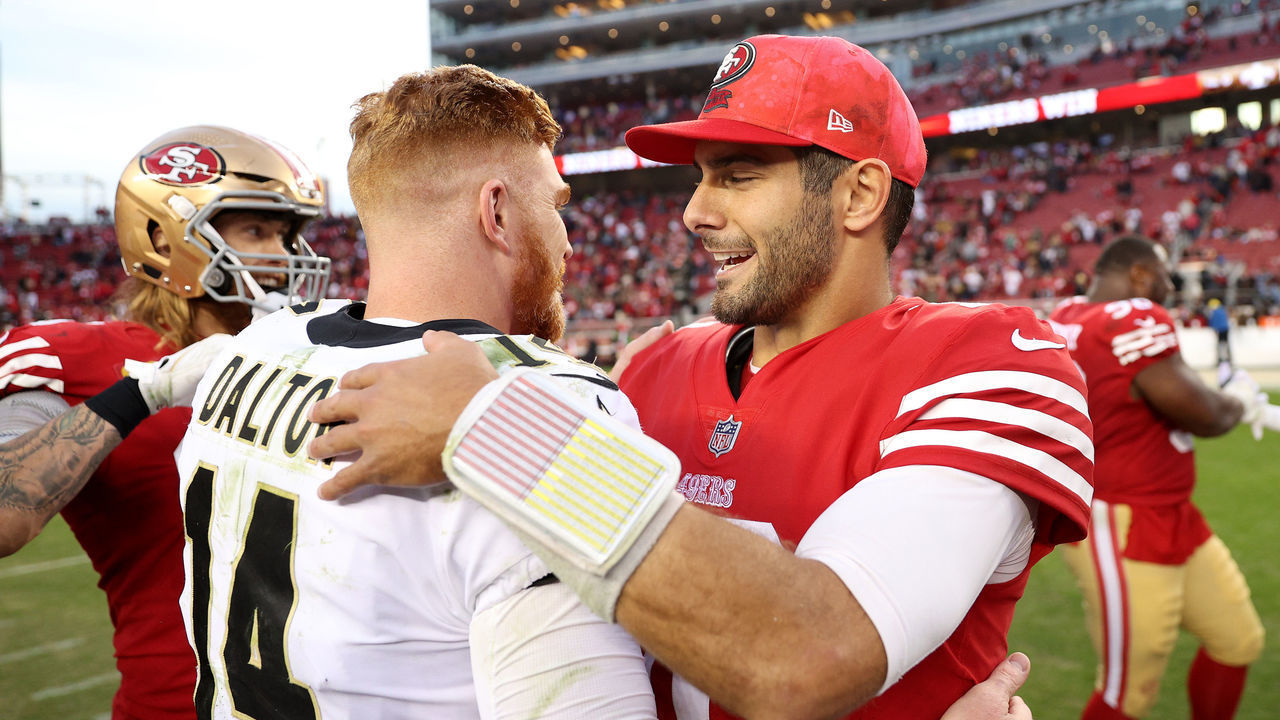 SANTA CLARA, CALIFORNIA - NOVEMBER 27: Jimmy Garoppolo #10 of the San Francisco 49ers and Andy Dalton #14 of the New Orleans Saints embrace after the game at Levi's Stadium on November 27, 2022 in Santa Clara, California.