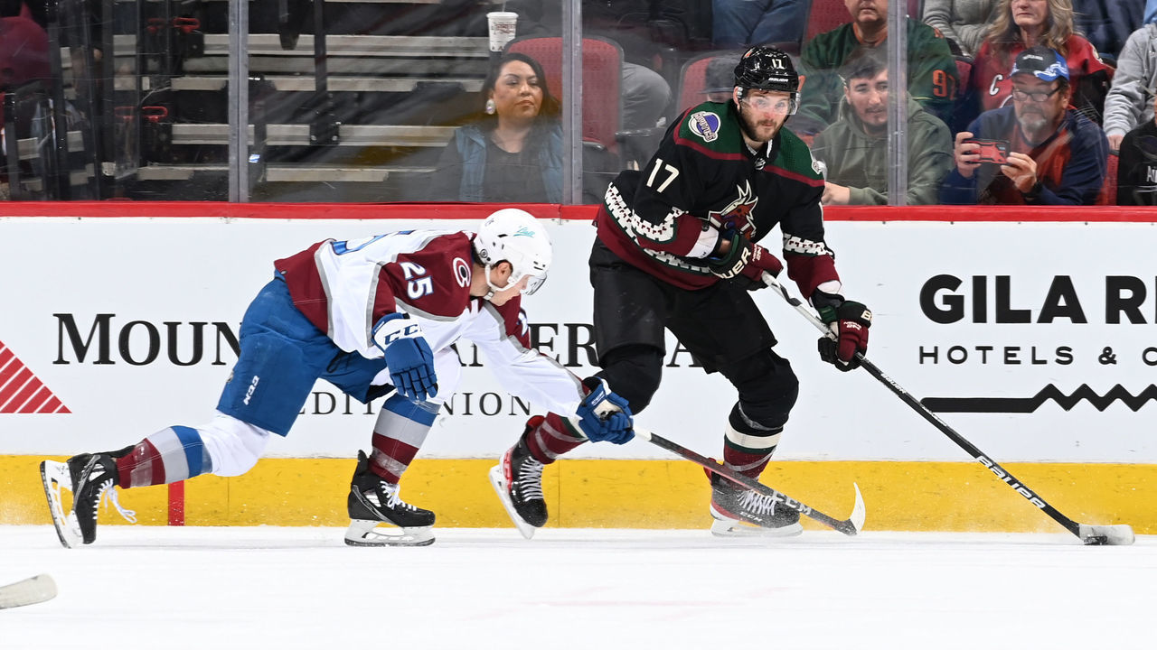 GLENDALE, ARIZONA - JANUARY 15: Alex Galchenyuk #17 of the Arizona Coyotes skates with the puck while being defended by Logan O'Connor #25 of the Colorado Avalanche during the second period at Gila River Arena on January 15, 2022 in Glendale, Arizona. Galchenyuk is playing in his 600th NHL game.