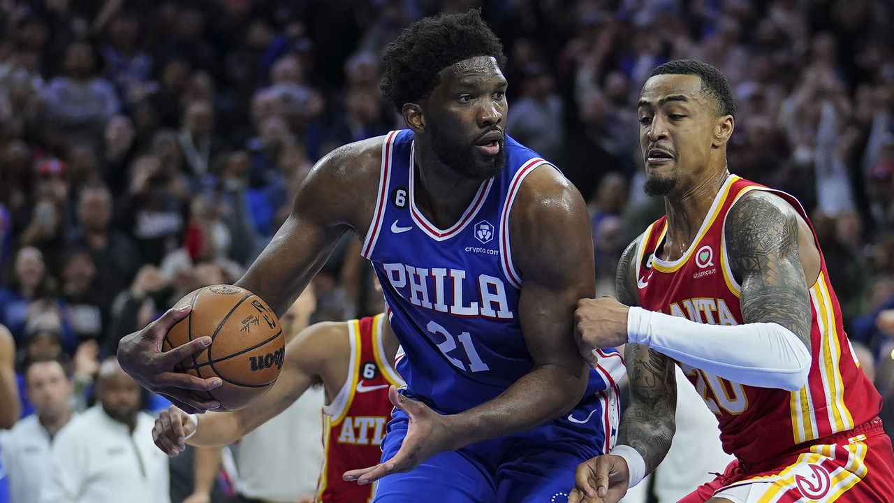 PHILADELPHIA, PA - NOVEMBER 28: Joel Embiid #21 of the Philadelphia 76ers controls the ball against John Collins #20 of the Atlanta Hawks in the fourth quarter at the Wells Fargo Center on November 28, 2022 in Philadelphia, Pennsylvania. The 76ers defeated the Hawks 104-101.
