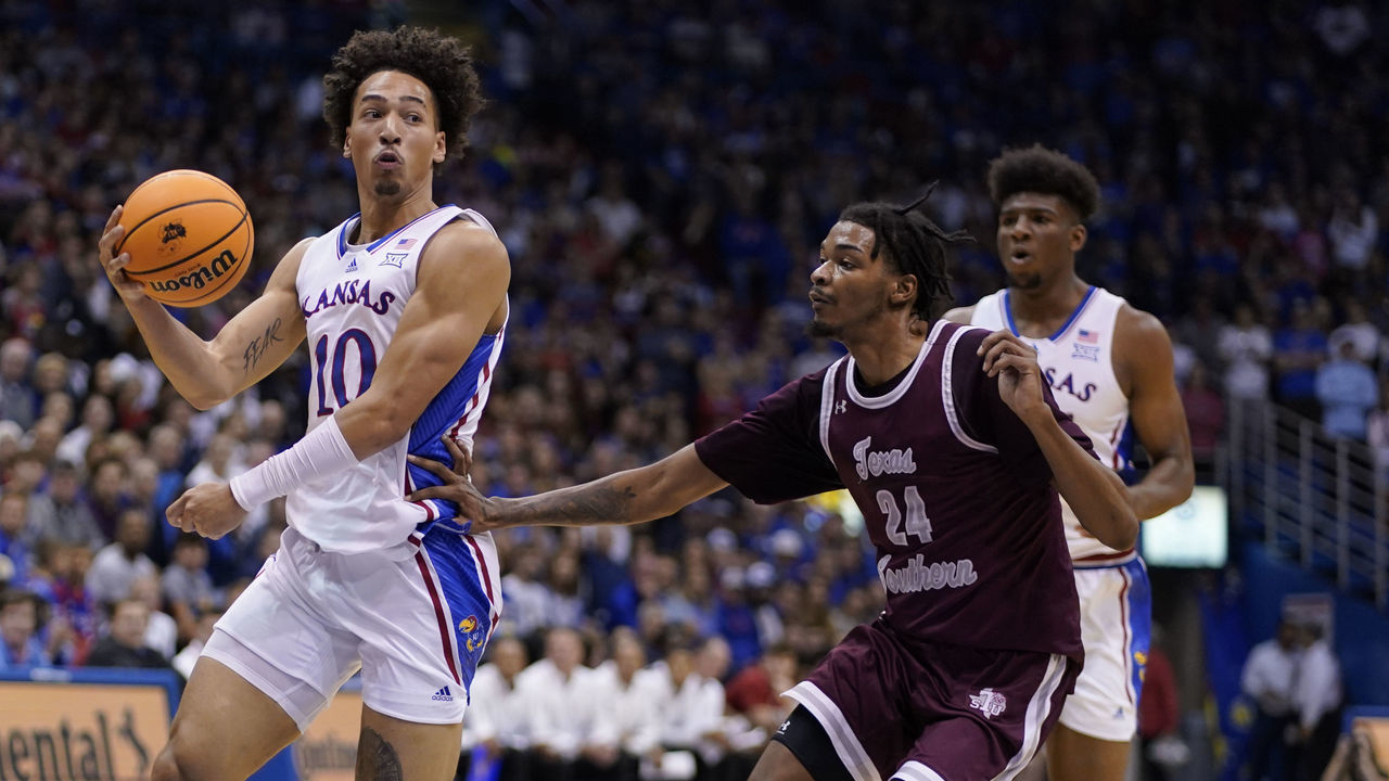 LAWRENCE, KANSAS - NOVEMBER 28: Jalen Wilson #10 of the Kansas Jayhawks passes the ball against John Walker III #24 of the Texas Southern Tigers in the second half at Allen Fieldhouse on November 28, 2022 in Lawrence, Kansas.