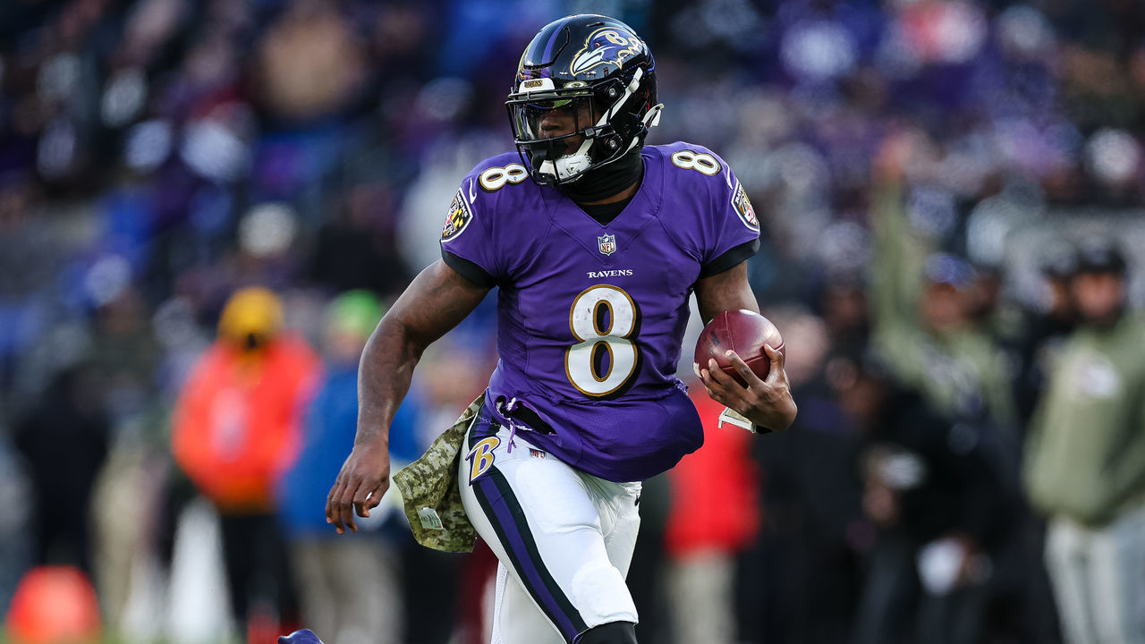 BALTIMORE, MD - NOVEMBER 20: Lamar Jackson #8 of the Baltimore Ravens carries the ball against the Carolina Panthers during the first half at M&T Bank Stadium on November 20, 2022 in Baltimore, Maryland.