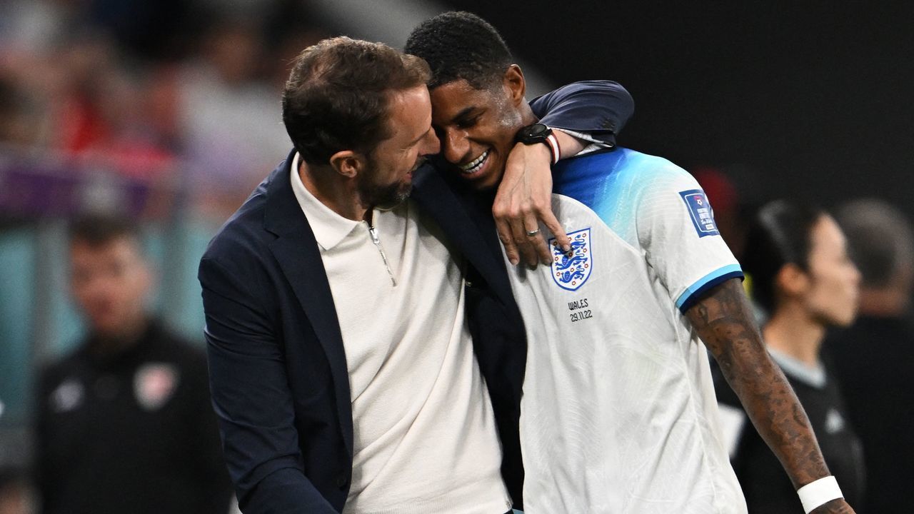 England's coach Gareth Southgate congratulates England's forward #11 Marcus Rashford as he is substituted after scoring two goals during the Qatar 2022 World Cup Group B football match between Wales and England at the Ahmad Bin Ali Stadium in Al-Rayyan, west of Doha on November 29, 2022.