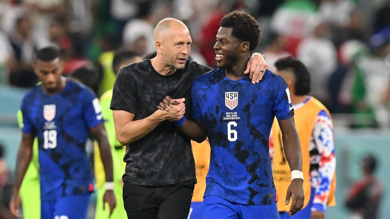USA's coach #00 Gregg Berhalter celebrates with USA's midfielder #06 Yunus Musah during the Qatar 2022 World Cup Group B football match between Iran and USA at the Al-Thumama Stadium in Doha on November 29, 2022.