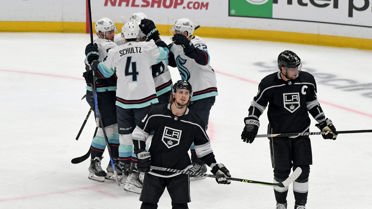 LOS ANGELES, CA - NOVEMBER 29: Seattle Kraken Defenceman Justin Schultz (4) celebrates with teammates after Seattle Kraken Center Matty Beniers (10) scored a first period goal during an NHL game between the Seattle Kraken and the Los Angeles Kings on November 29th, 2022, at the Crypto.com Arena in Los Angeles, CA.